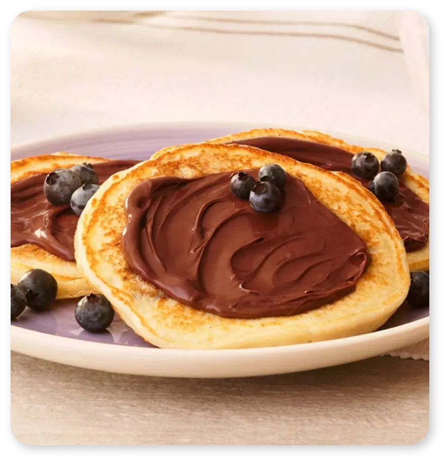 plate of pancakes with nutella and blueberries