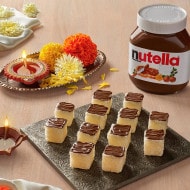 Coconut barfi squares decorated with Nutella for Diwali celebrations.