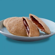 Goan poie flatbread spread with Nutella and topped with sliced bananas.