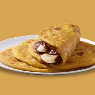 Maharashtra puranpoli flatbread served with Nutella and powdered sugar.