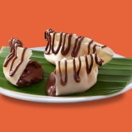 West Bengal-style momos filled with Nutella, presented with dipping sauce.