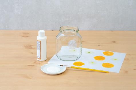 Nutella jar candle craft step showing decorative assembly.