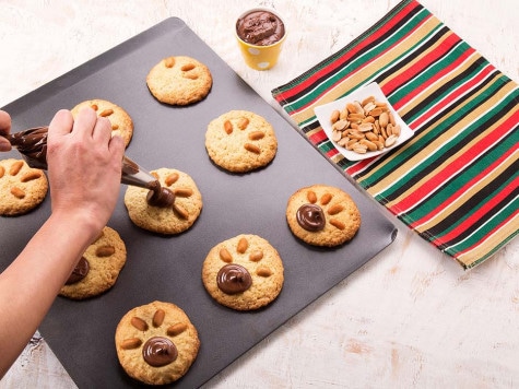 Bear-paw cookies stamped and filled with Nutella in final stage.