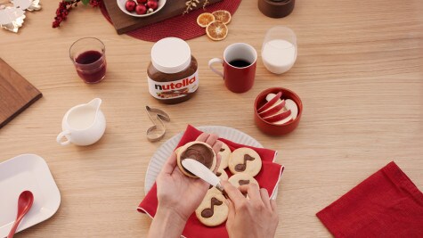 Christmas note cookies decorated with Nutella and festive icing.