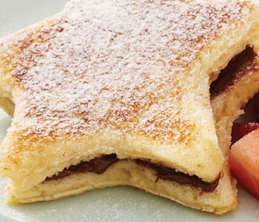 Thick French toast slices layered with Nutella and fresh berries.