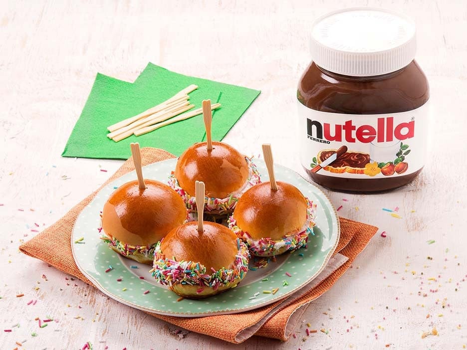 Small panini spread with Nutella and decorated with colorful sugar sprinkles.