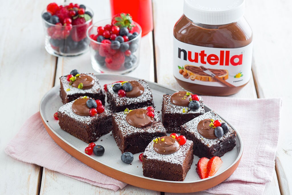 Quadrotti dolci al cioccolato ripieni di Nutella, tagliati a cubetti.
