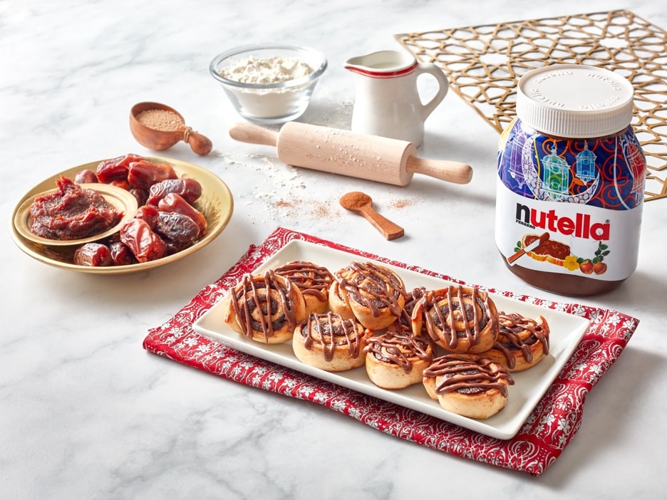 Traditional kleicha cookies filled with dates, arranged on a plate.