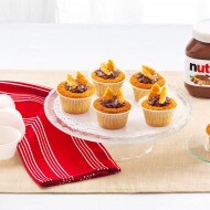 Vanilla cupcakes filled and topped with Nutella and chocolate shavings.