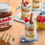 Darabeel sesame cookies drizzled with Nutella and arranged on a plate.