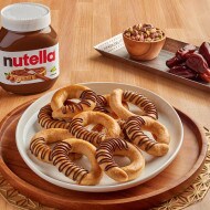 Dates ka'ak cookies filled with Nutella and rolled in sesame seeds.