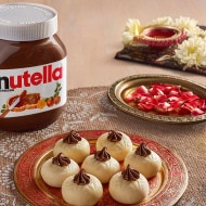 Doodh peda sweets decorated with Nutella for Diwali celebrations.