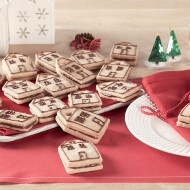 Shortbread sandwich cookies filled with Nutella presented in a dessert card.