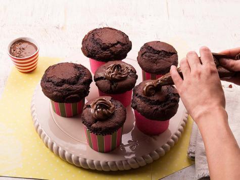 Filling chocolate mousse cupcake shells with Nutella and garnishing, step three.