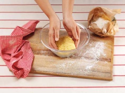 Assembling Baci di Dama cookies with Nutella filling, recipe step one.