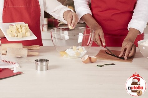 Cutting cookie shapes from dough to later fill with Nutella, recipe step one.