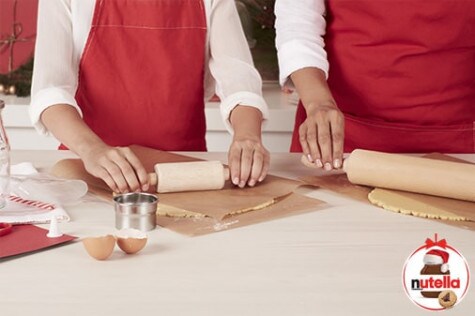 Applying Nutella filling to cut-out cookie bases, recipe step three.