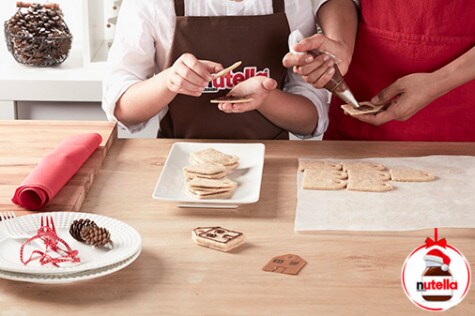 Shortbread sandwiches arranged in rows, Nutella center visible between cookies.