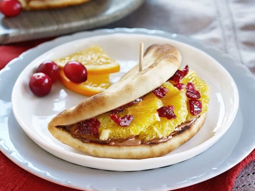 Naan tacos folded with Nutella, banana slices, and crushed nuts.