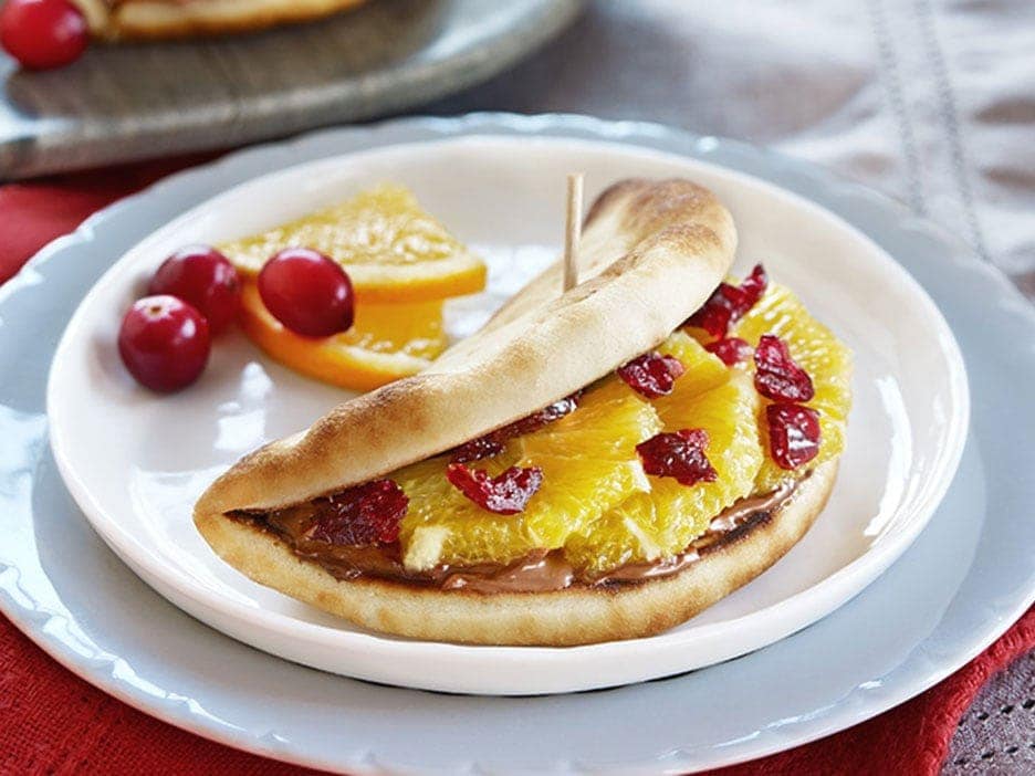 Naan tacos folded with Nutella, banana slices, and crushed nuts.