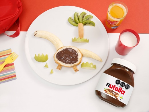 Galleta con forma de dinosaurio decorada con Nutella y glaseado colorido.