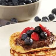 Mini blueberry buttermilk pancakes with Nutella® and strawberries