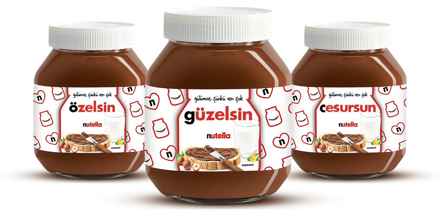 Three Nutella jars with personalised labels 'amazing', 'special', and 'lovely' on a vibrant red background