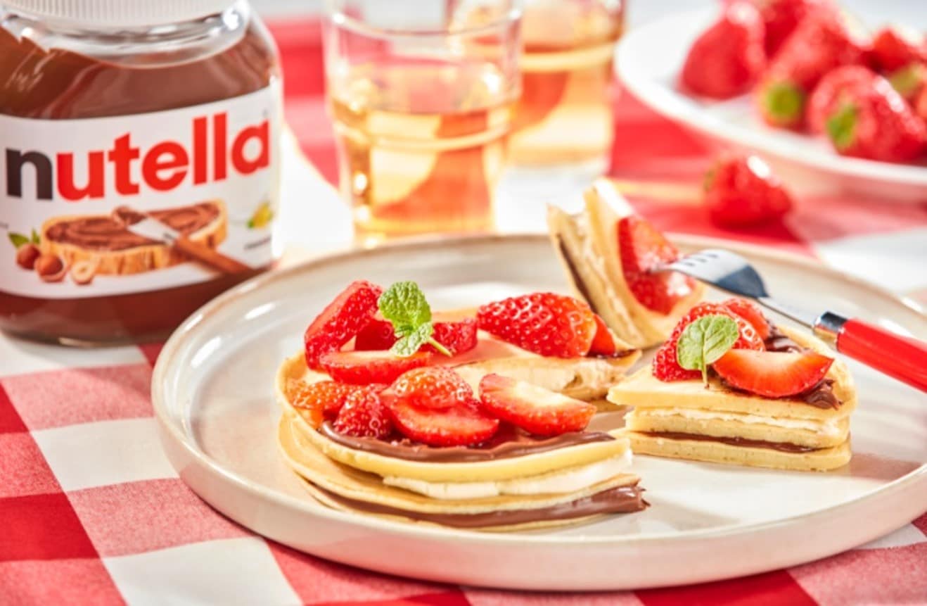 Strawberry and mascarpone pancakes drizzled with Nutella and maple syrup.