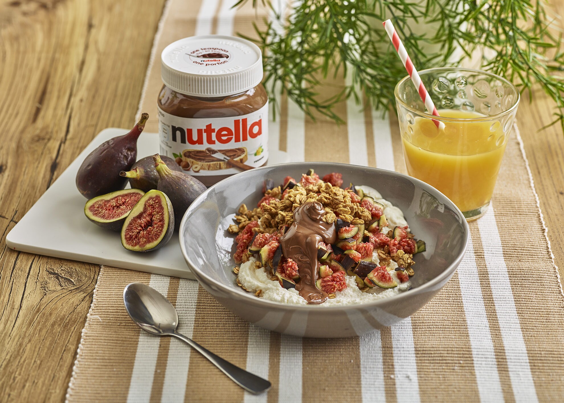 Breakfast figs topped with Nutella and chopped nuts.