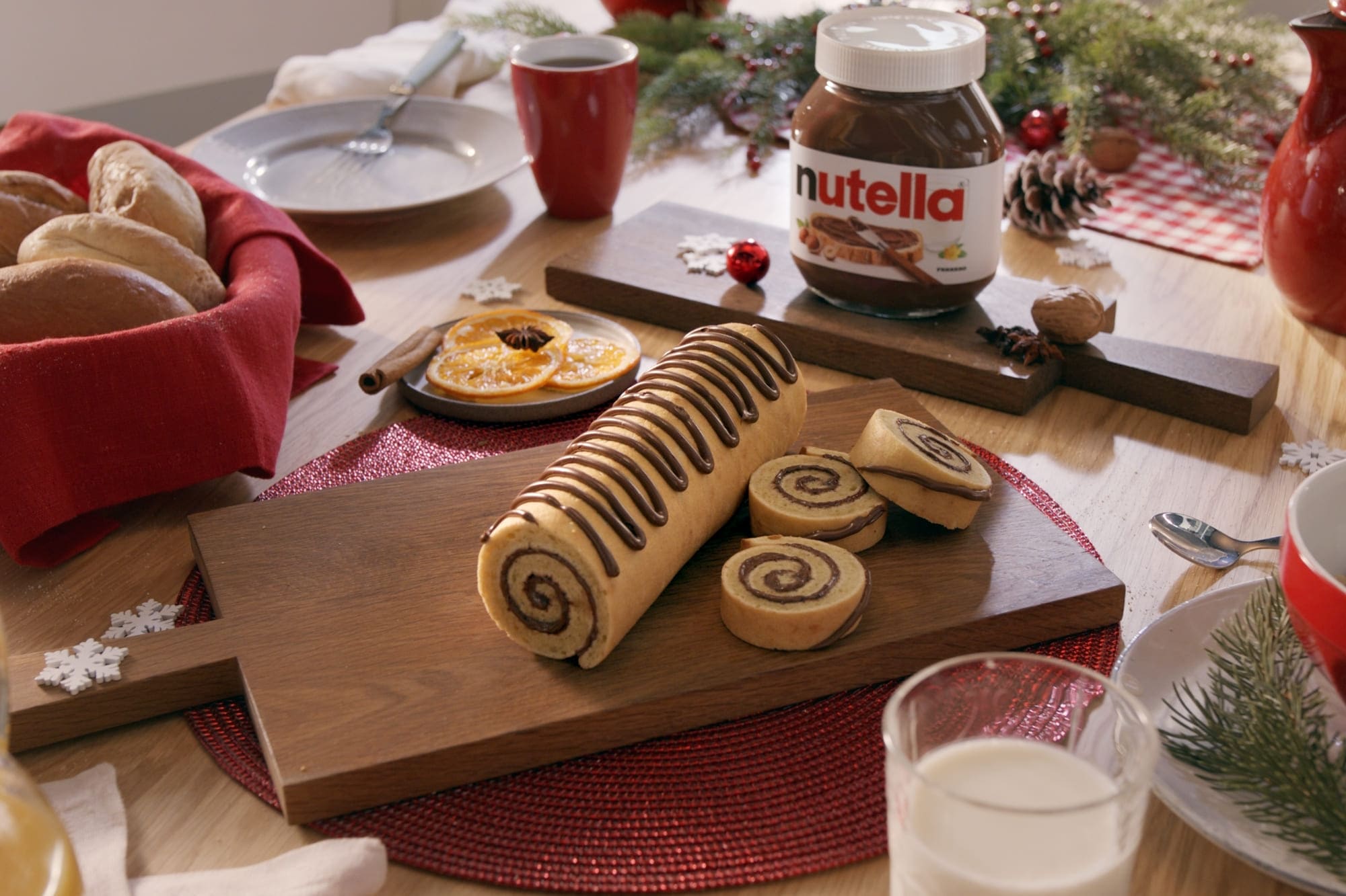 Nutella yule log with chocolate ganache and cream decoration.