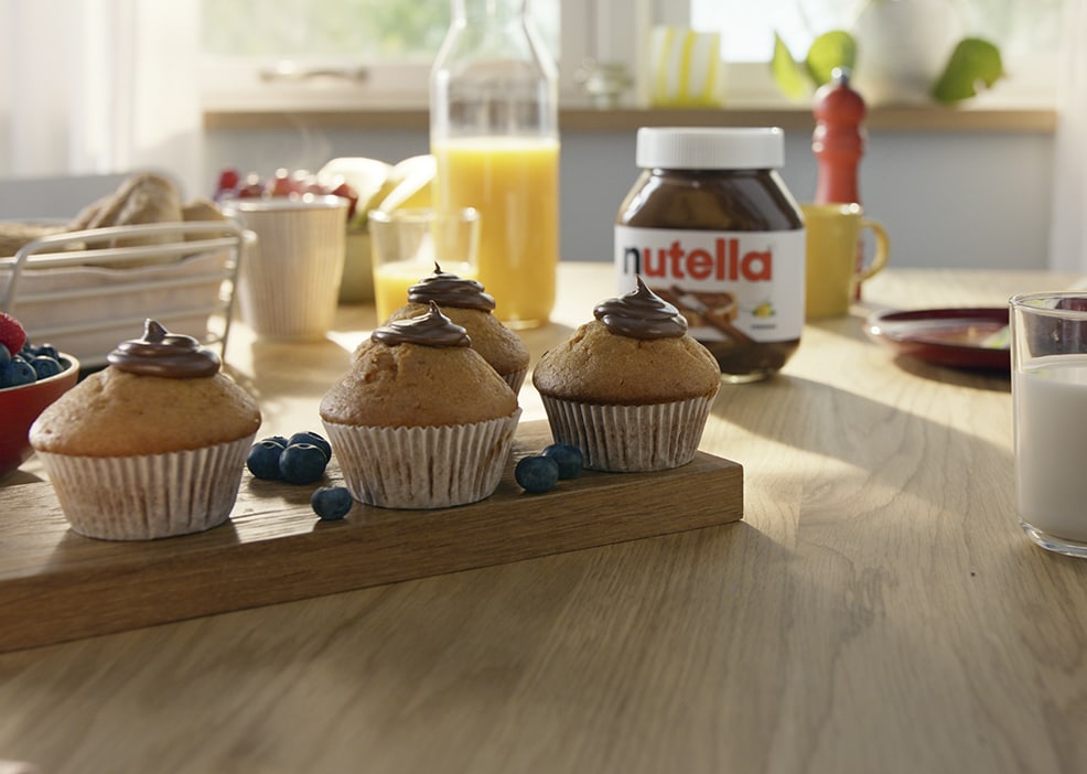 Hazelnut cupcakes topped with Nutella frosting and chopped hazelnuts.