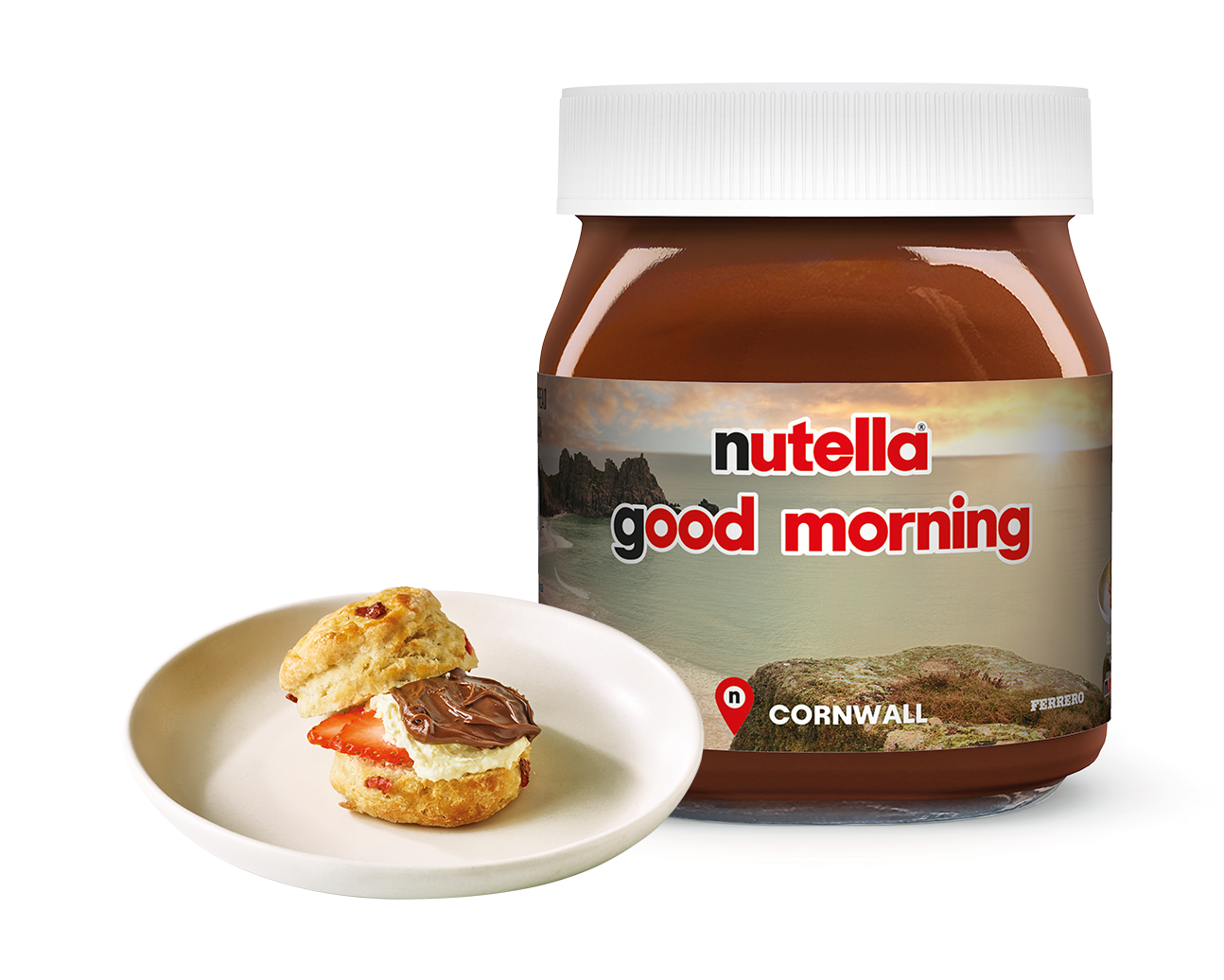 A jar of Nutella with good morning and a scenic landscape on the label. Next to it, a plate holds a scone layered with cream, strawberry slices, and Nutella spread. The word Cornwall is also visible on the jar.