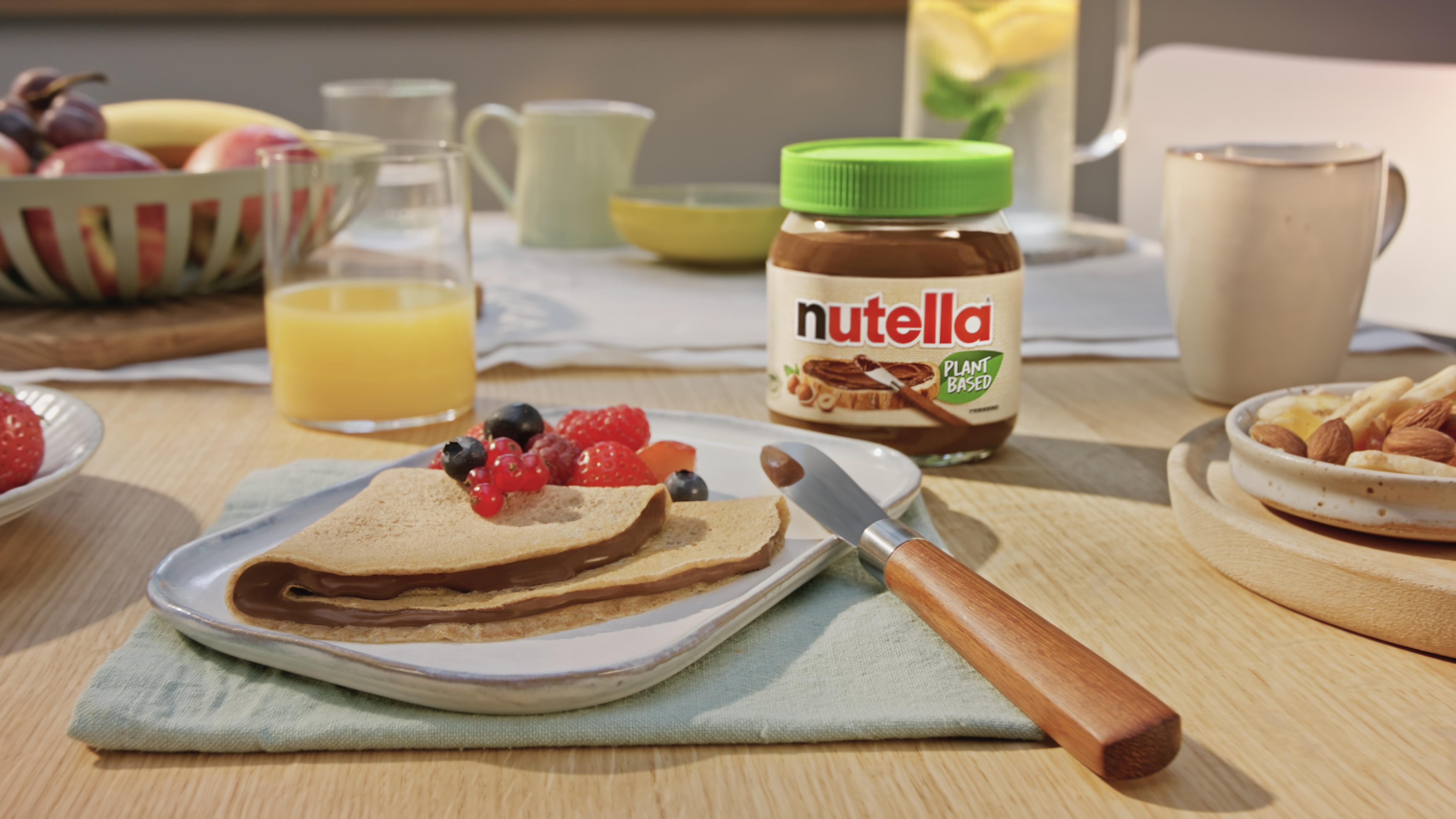 Vegan Nutella crepes folded with plant-based spread and sliced fruit garnish.