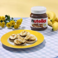 Step two: spreading Nutella on star-shaped English muffins, adding berries.