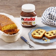 Sliced brioche topped with Nutella and candied citrus fruits, plated dessert.