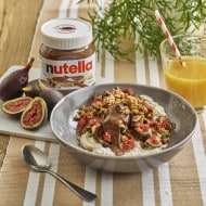 Breakfast figs topped with Nutella and chopped nuts.