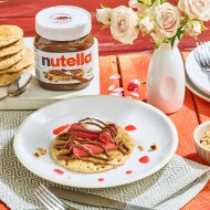 Rhubarb pikelets drizzled with Nutella and served with cream.
