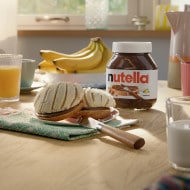 Concha sweet bun split and filled with Nutella, sugar topping.