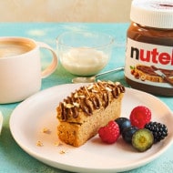 Sliced banana bread loaf with Nutella swirls, rustic serving plate.