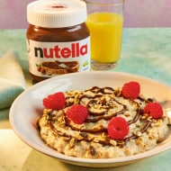 Scones halved and spread generously with Nutella, ready to serve.