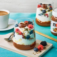 Yogurt bowl topped with Nutella swirl, granola and fresh berries.