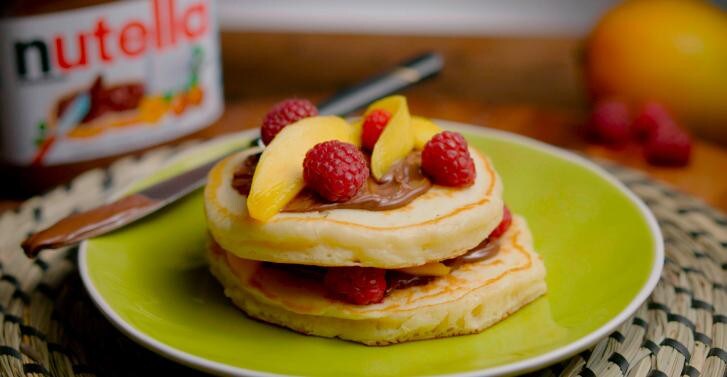 Fluffy buttermilk pancakes with nutella®, mango & raspberries