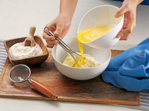 Recipe step one for ciambella cake showing batter with Nutella ribbon.