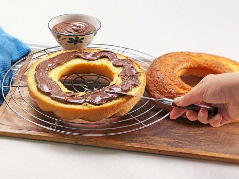 Whole ciambella cake with Nutella swirls, plated homemade dessert.