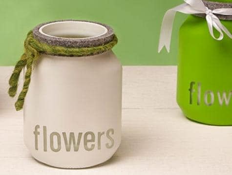 Step five: finishing Nutella jar candle craft with floral decoration.