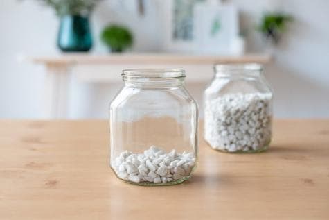 DIY Nutella jar craft step one showing plant-themed jar decoration materials.