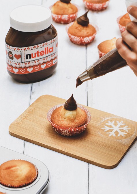 Whole gluten-free orange sponge cake with Nutella layer and citrus garnish.