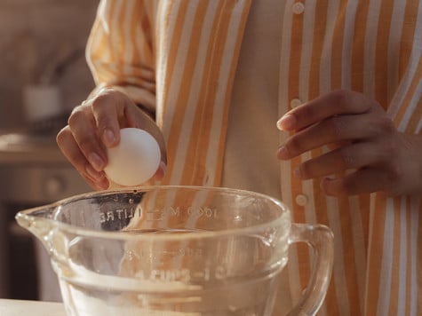 Spreading Nutella on sliced brioche with candied citrus fruit, step two.