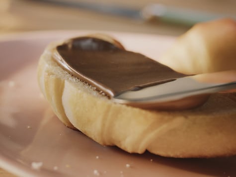 Adding ribbon and labels to Nutella workshop jars, step four.