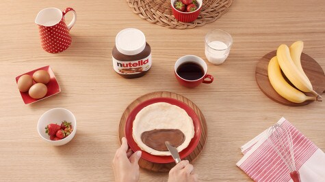 Assembling Nutella jar spa gift with oils and labels, step three.